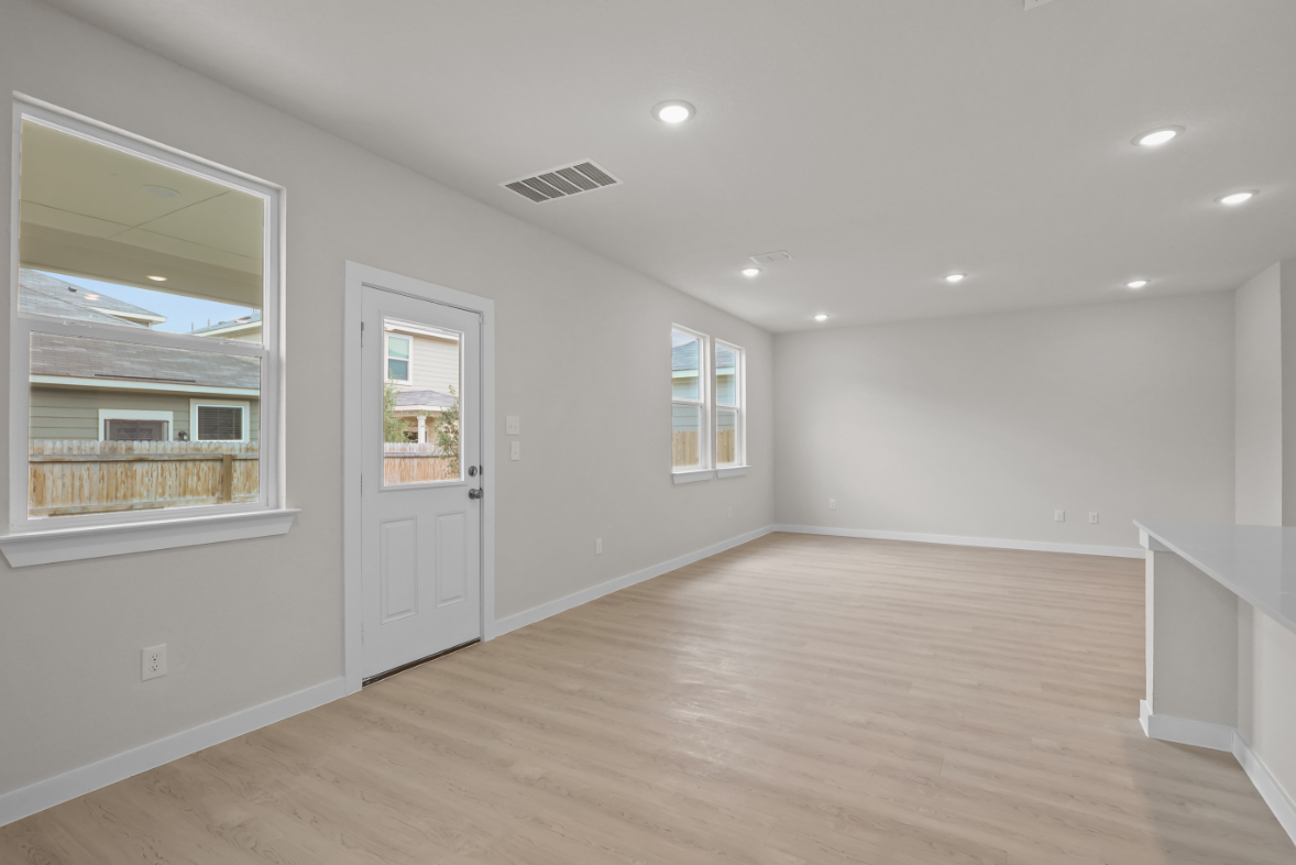 A room with white walls and a wood floor.