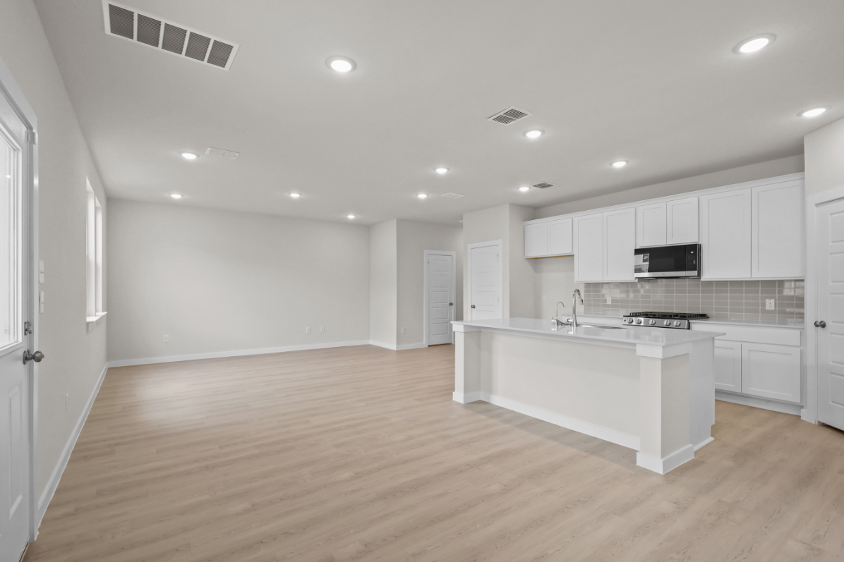 A kitchen with white cabinets.