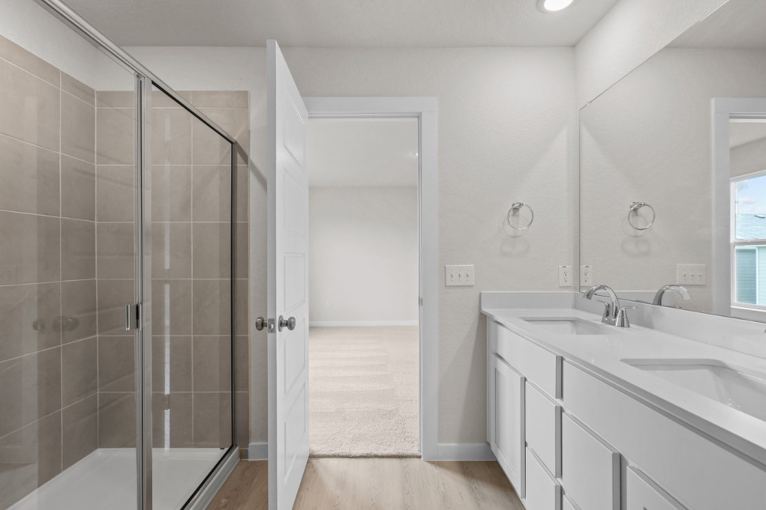 A bathroom with a shower and sink.