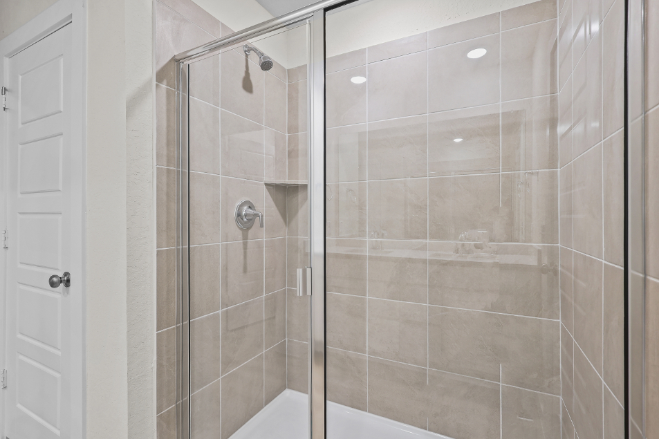 A shower with a glass door.