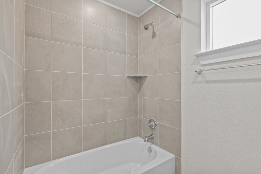 A bathtub in a bathroom.