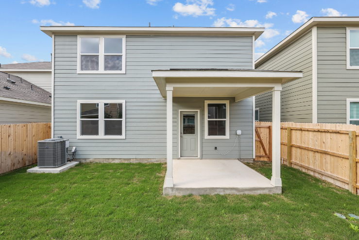 A house with a fence and grass.