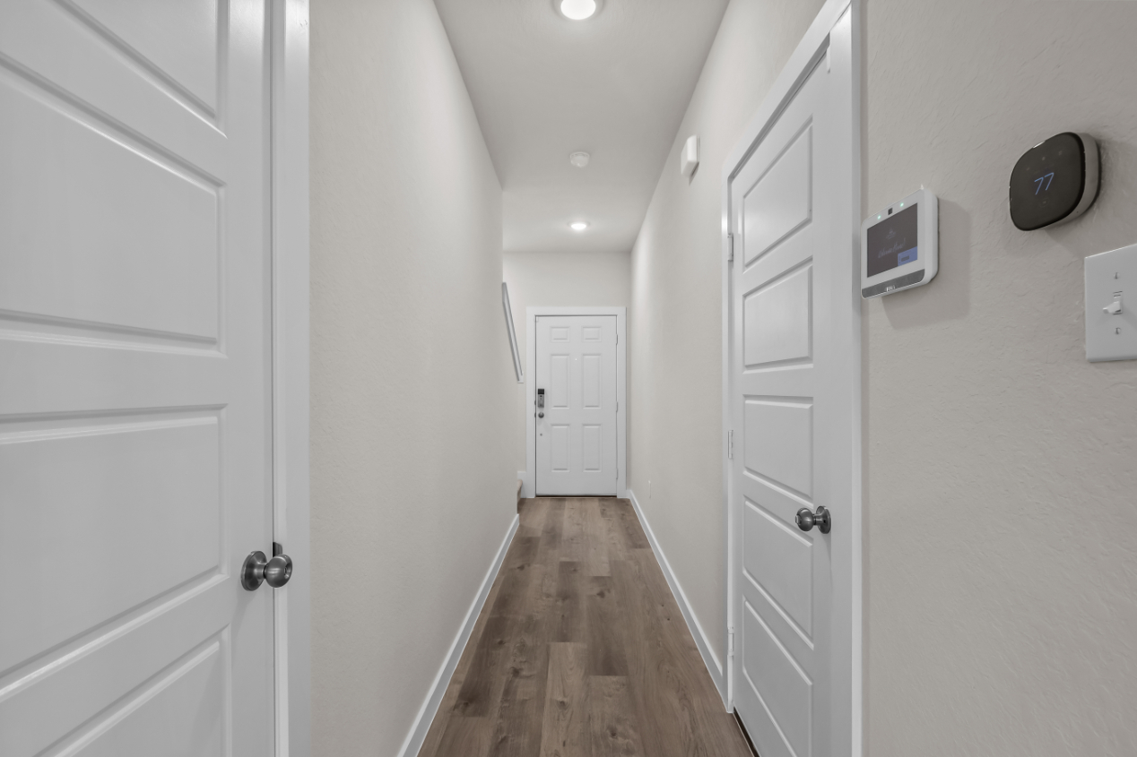 A hallway with white doors.