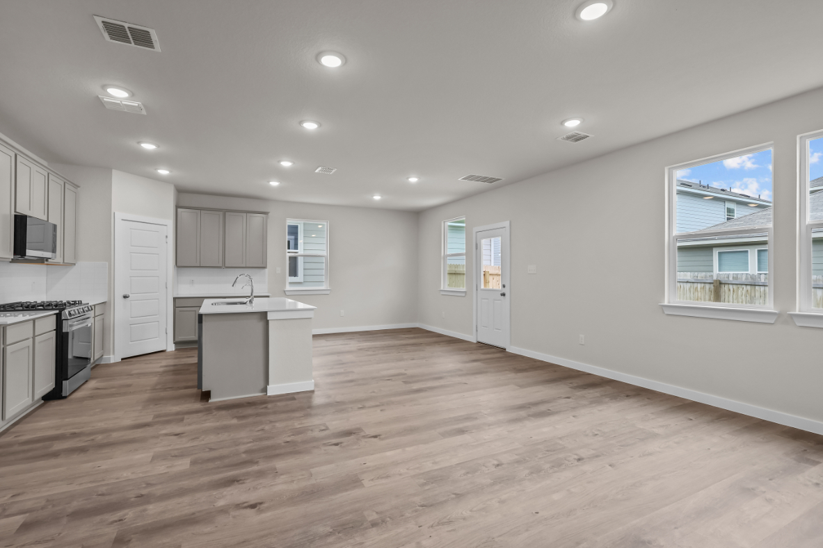 A kitchen with white cabinets.