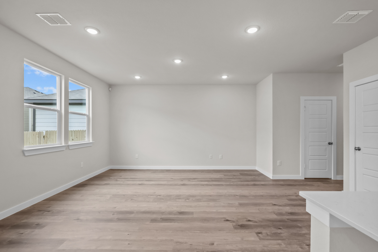 A room with a wood floor and white walls.