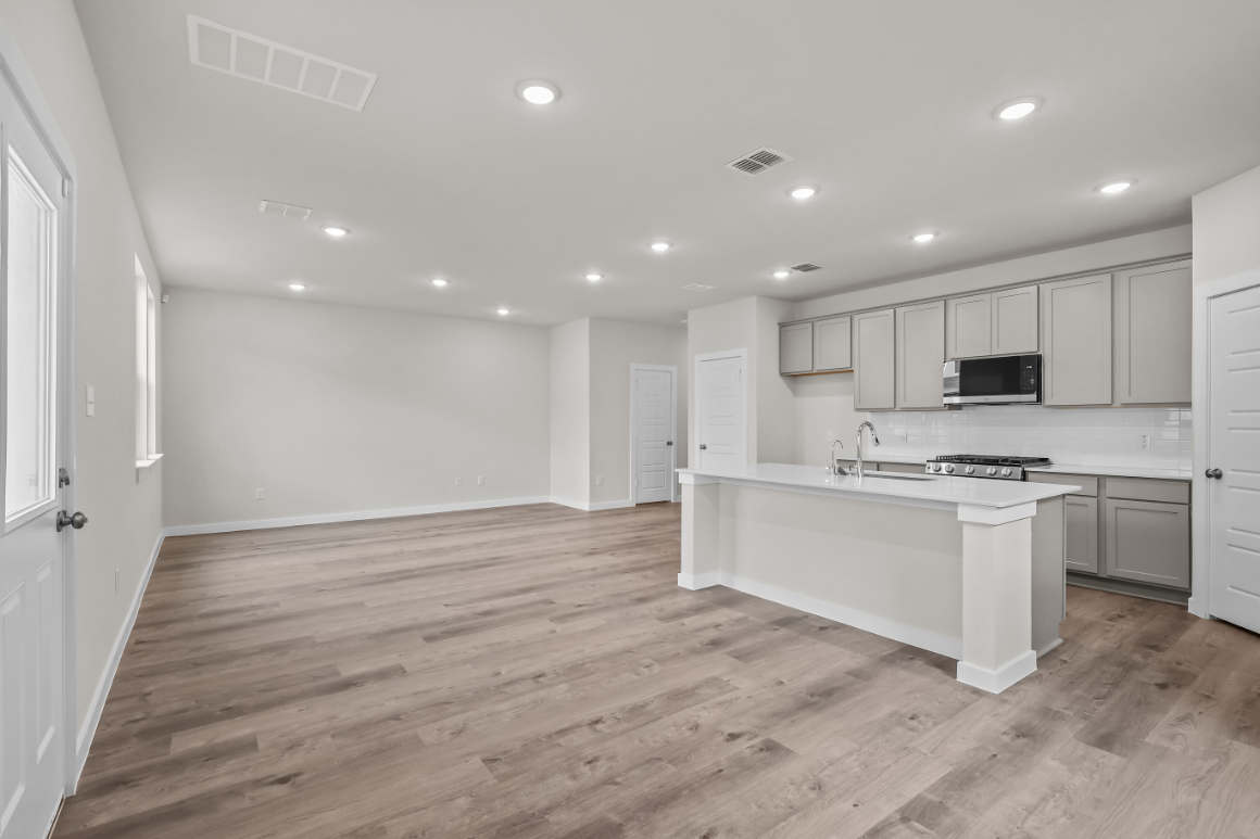 A kitchen with white cabinets.