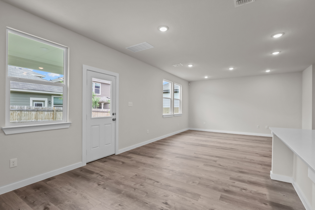 A room with a wood floor and white walls.