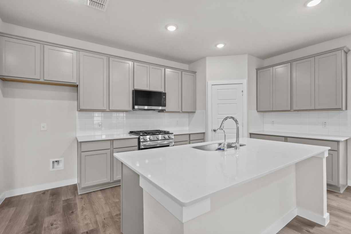 A kitchen with white cabinets.