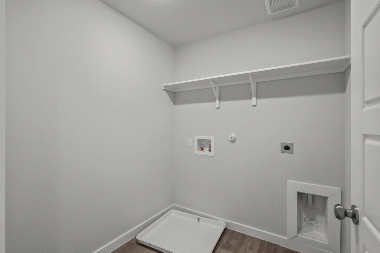 A white bathroom with a sink and a white wall.