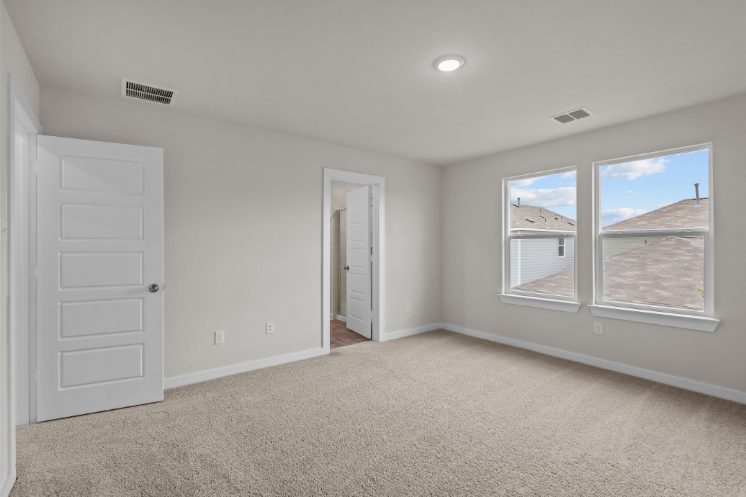 A room with white walls and a window.