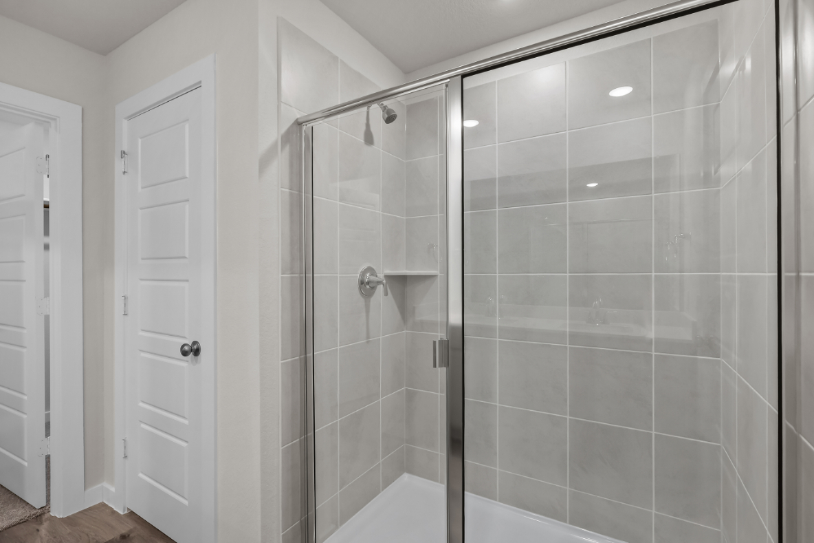 A shower with glass doors.