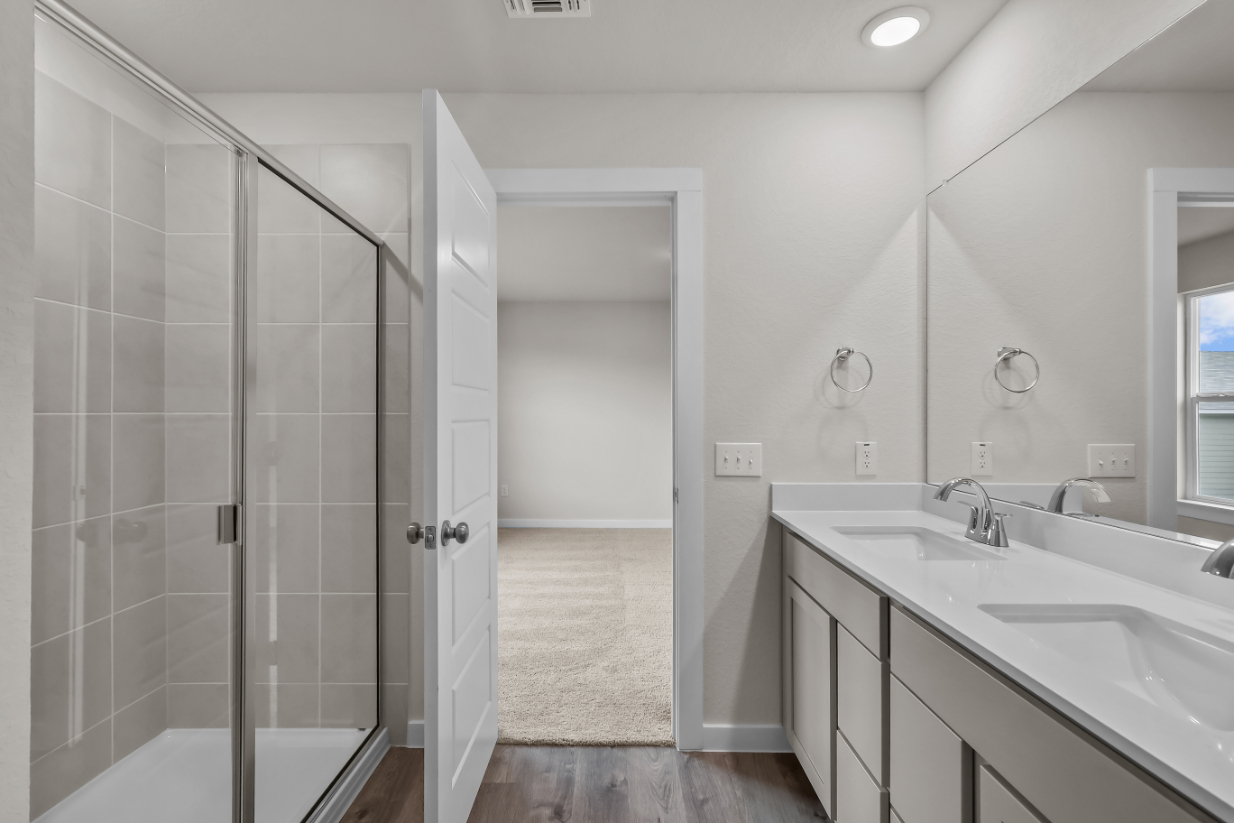A bathroom with a shower and sink.