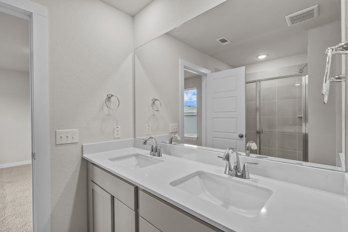 A bathroom with a large mirror.