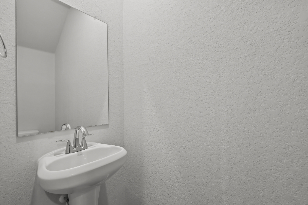 A bathroom with a mirror and sink.