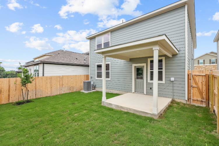 A house with a fence and grass.