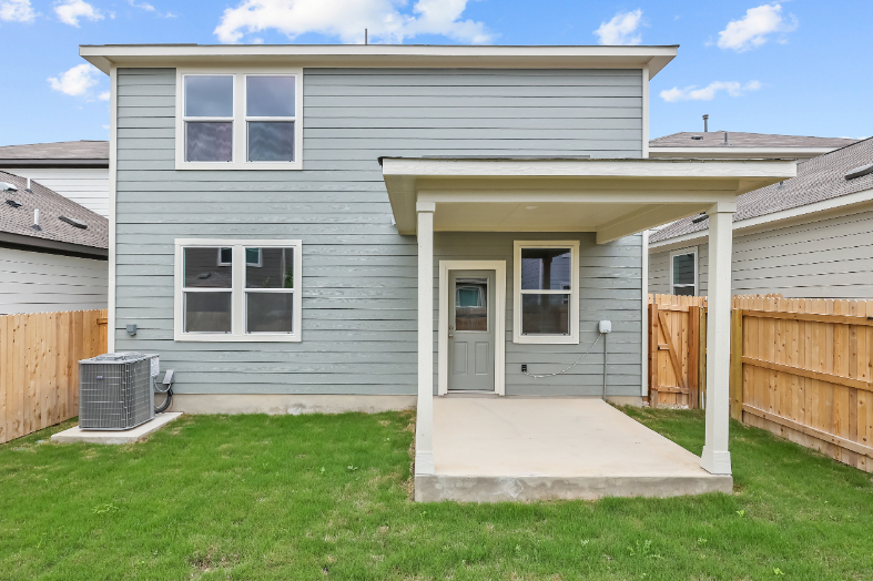 A house with a fence and grass.