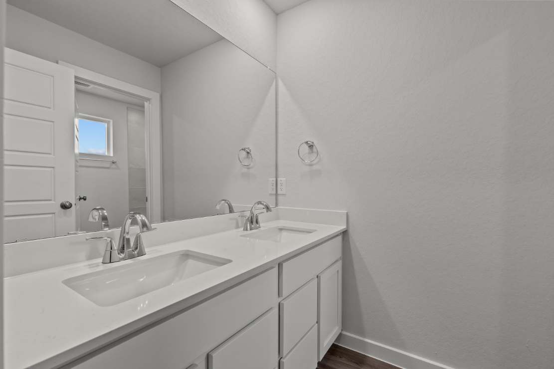 A bathroom with a large mirror.