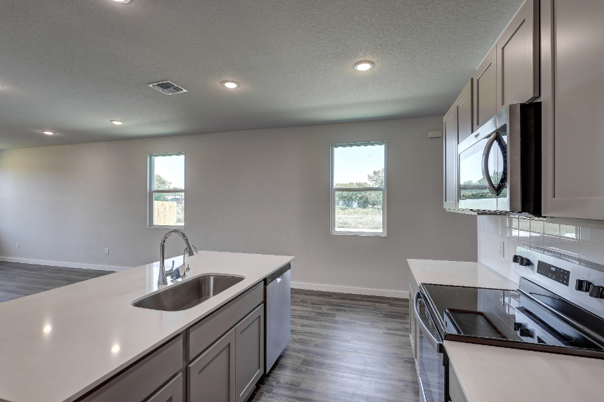 A kitchen with black cabinets.