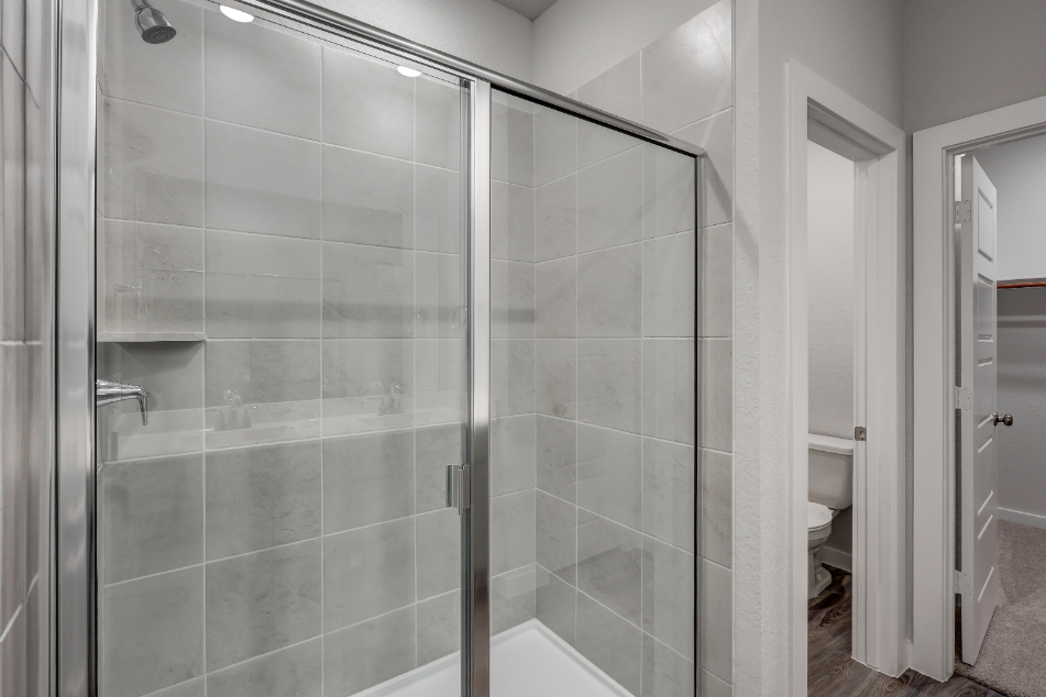 A shower with glass doors.