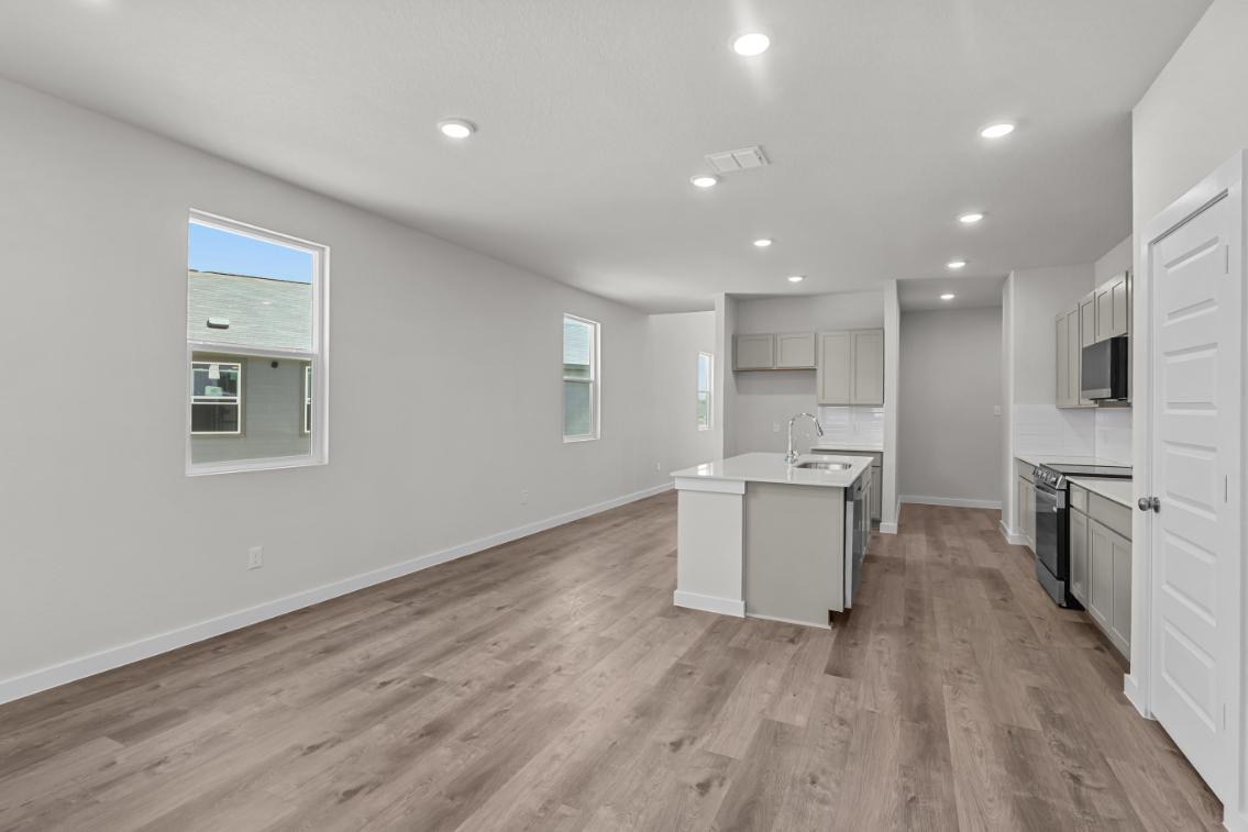 A kitchen with white cabinets.
