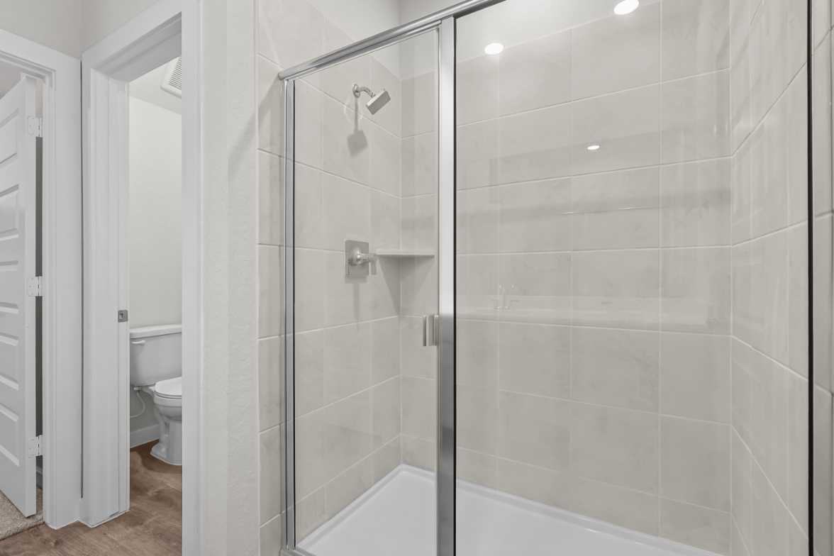 A bathroom with a glass shower.