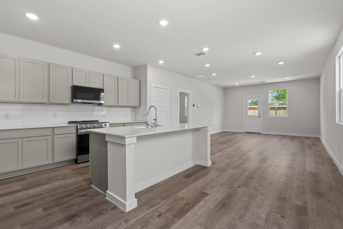 A kitchen with white cabinets.