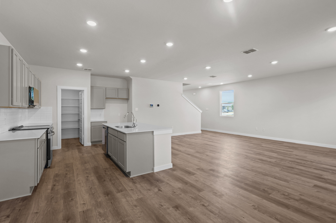 A kitchen with white cabinets.