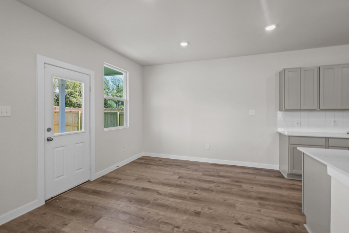 A room with white walls and a wood floor.
