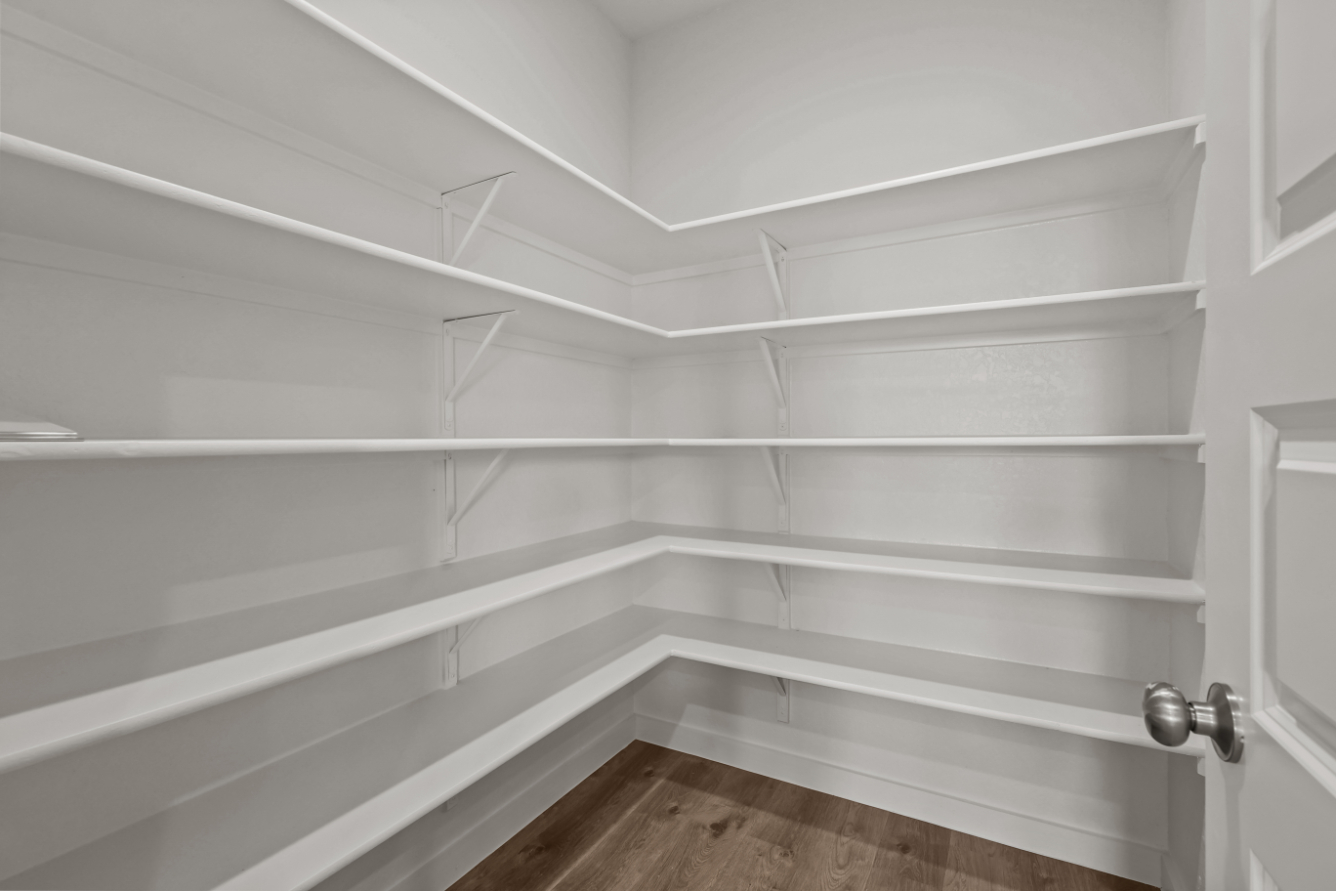 A white staircase with a wooden floor.