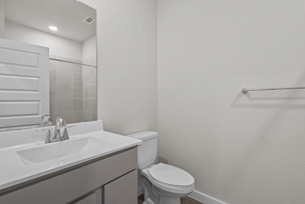 A bathroom with a sink toilet and a bathtub.