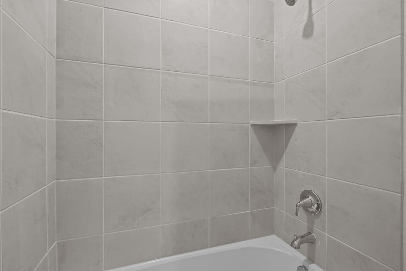 A white tiled bathroom.