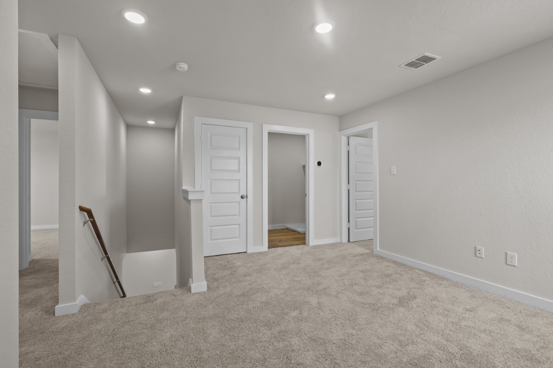 A room with white walls and a staircase.