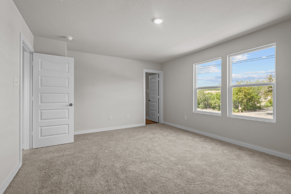 A room with a window and a door.