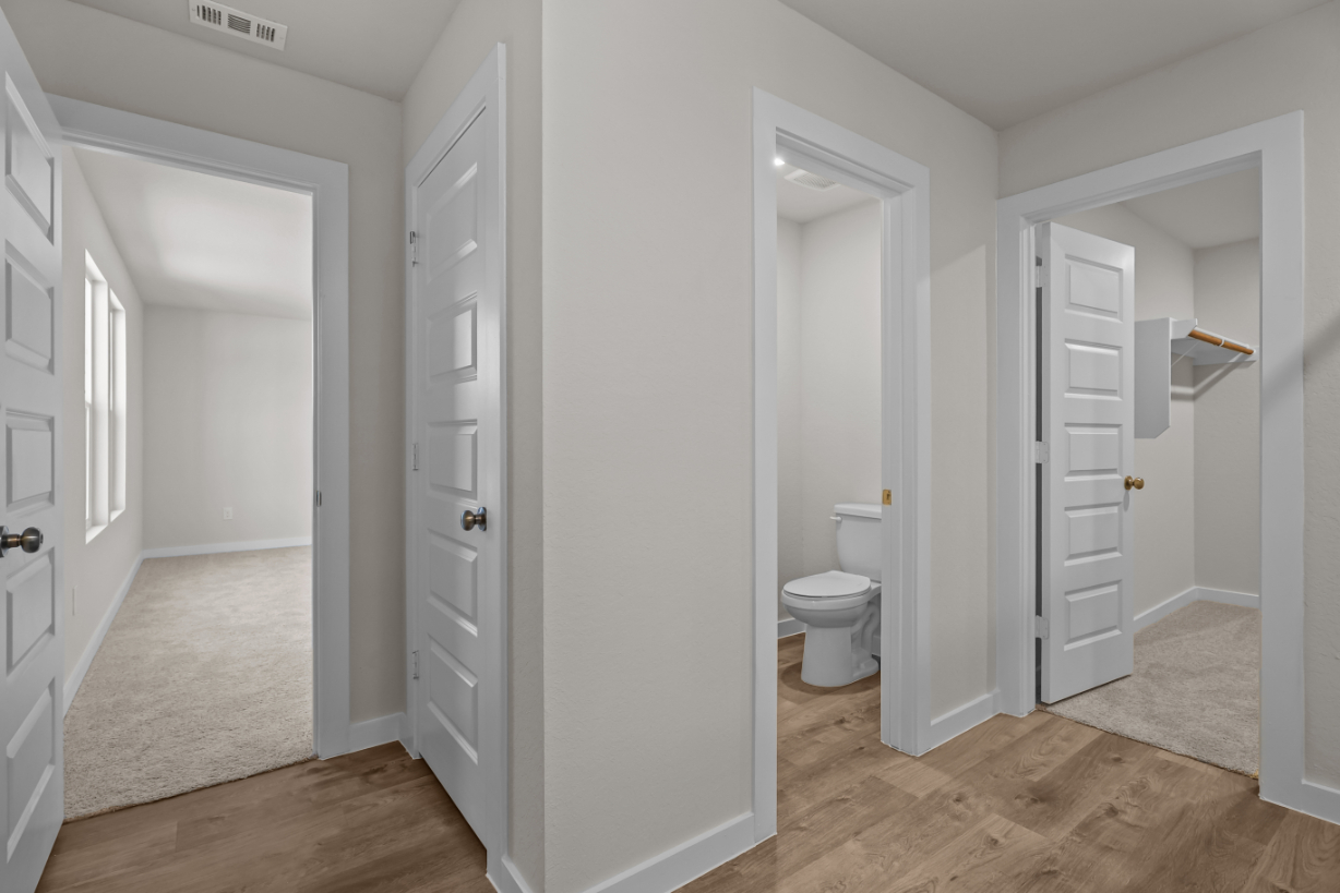 A bathroom with white cabinets.