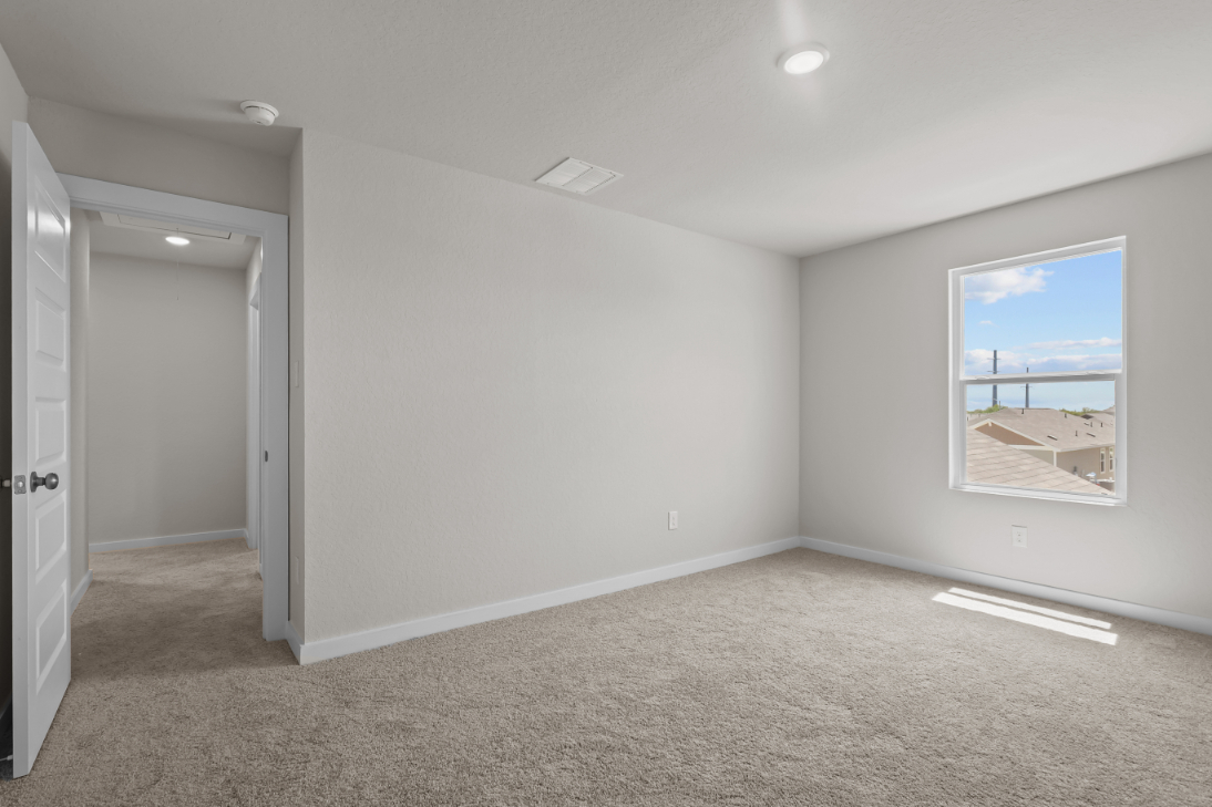 A room with a window and a door.