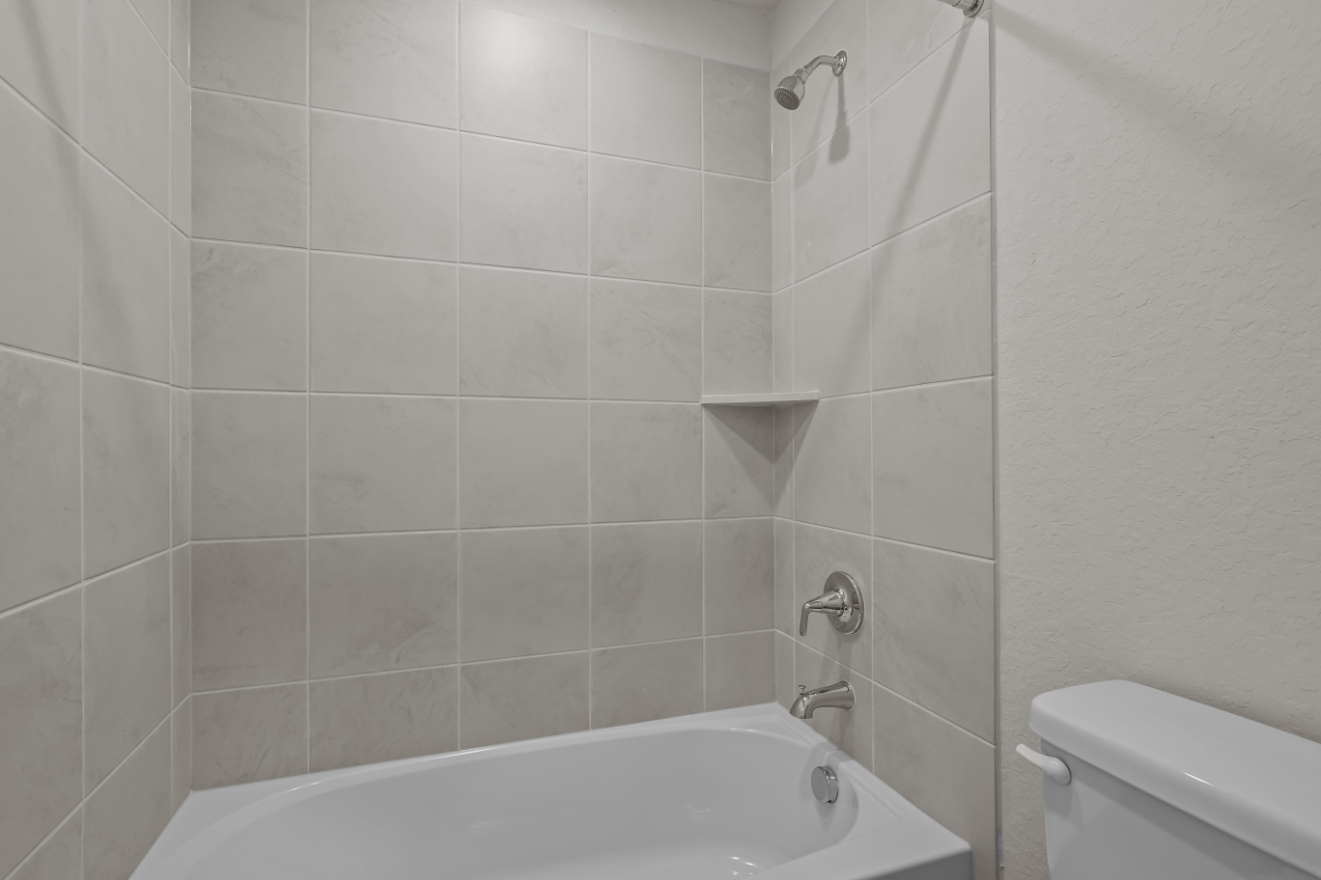 A bathroom with a bathtub and toilet.