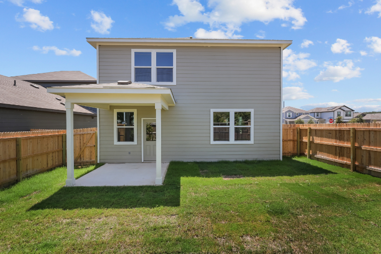 A house with a fence and grass.
