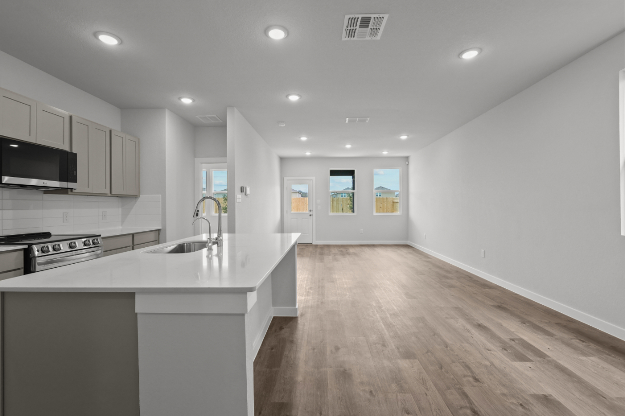 A kitchen with white cabinets.