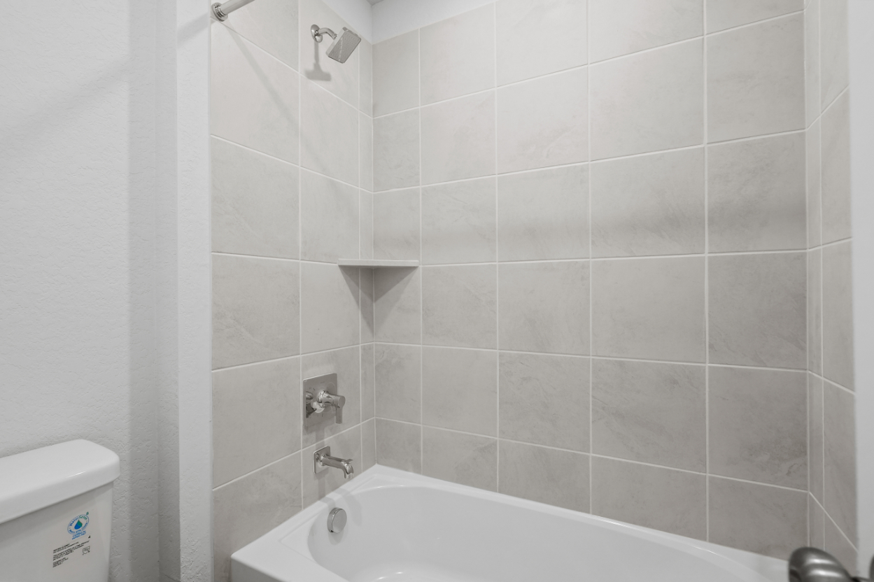 A white tiled bathroom.