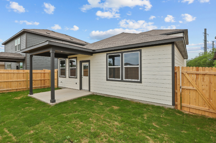 A house with a fence and grass.