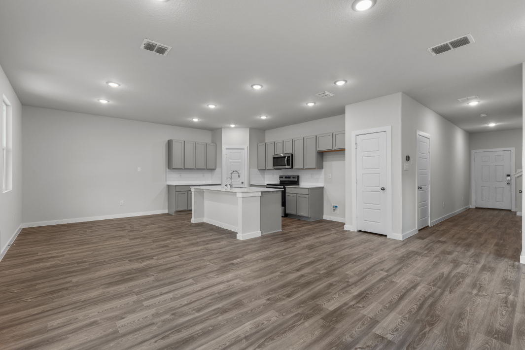 A kitchen with white cabinets.