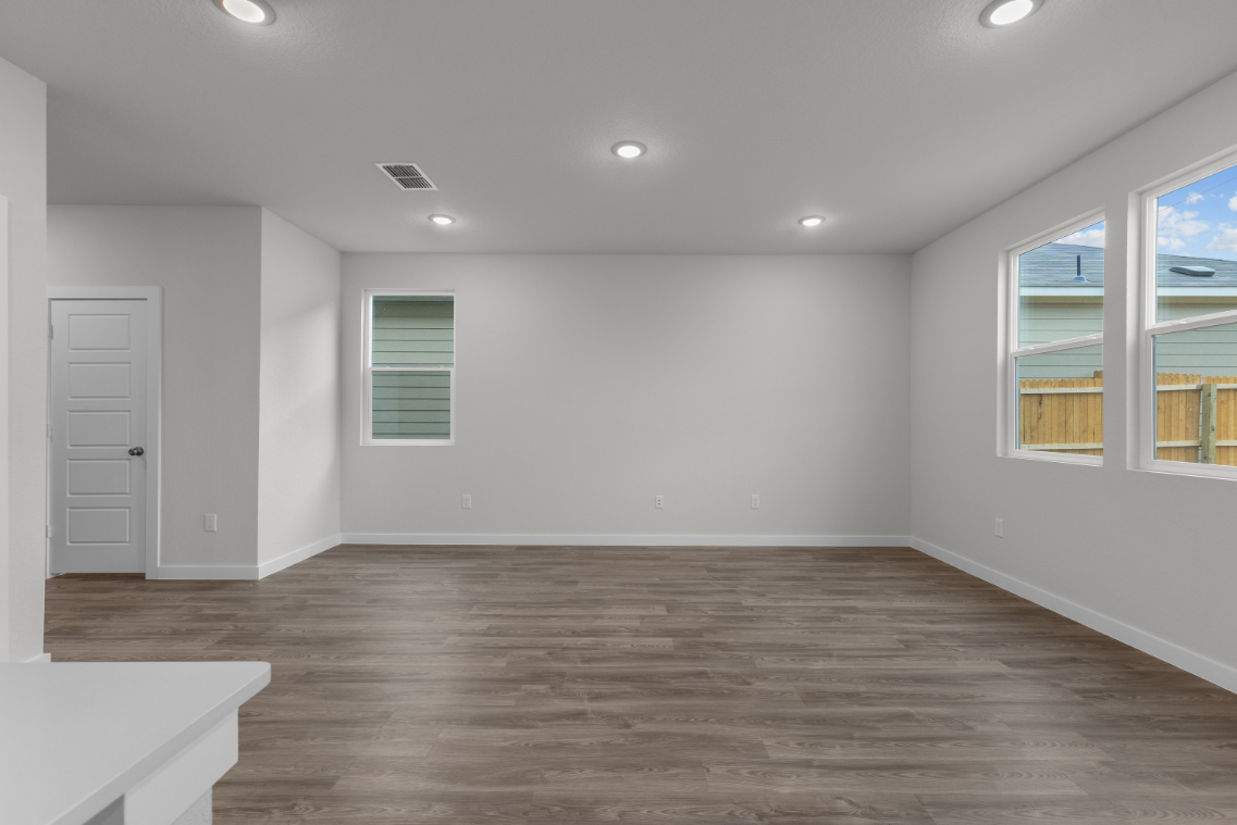 A room with a wood floor and white walls.