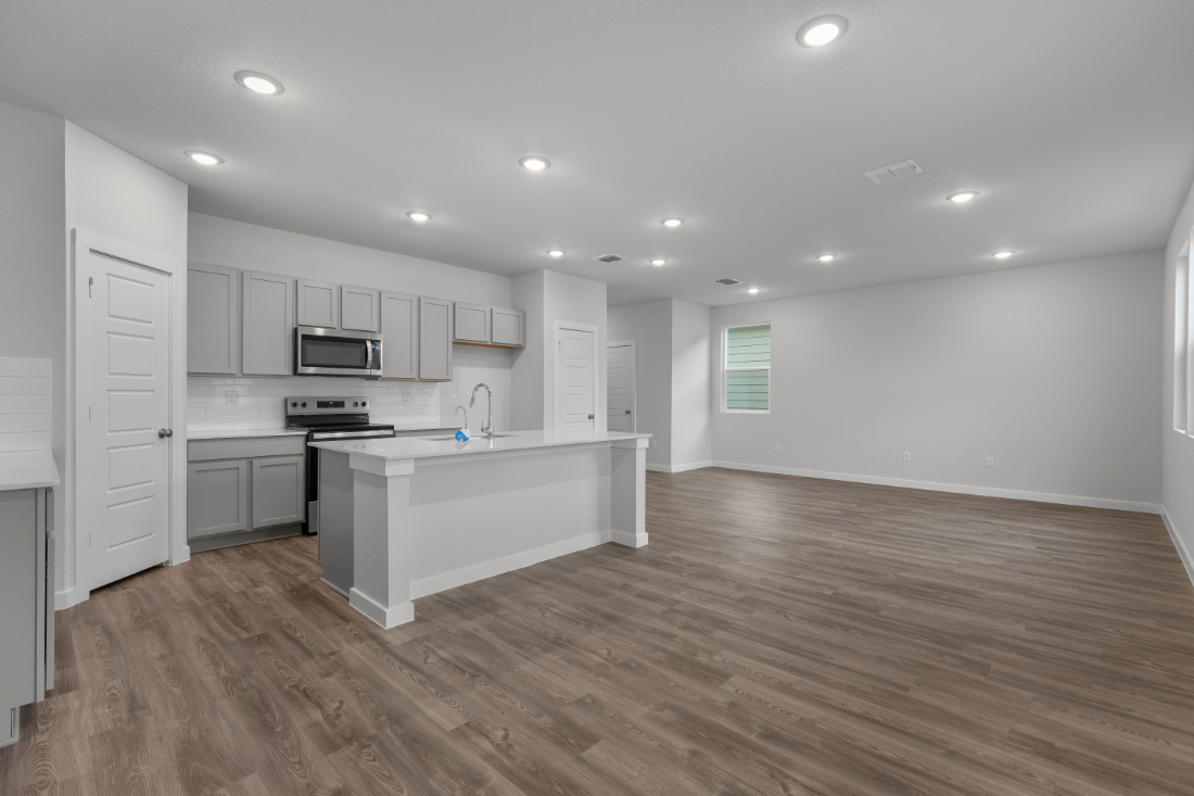 A kitchen with white cabinets.