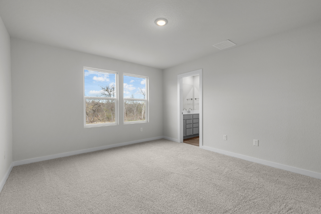 A room with a white wall and a window.