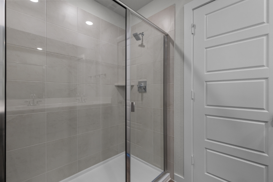A shower with a glass door.