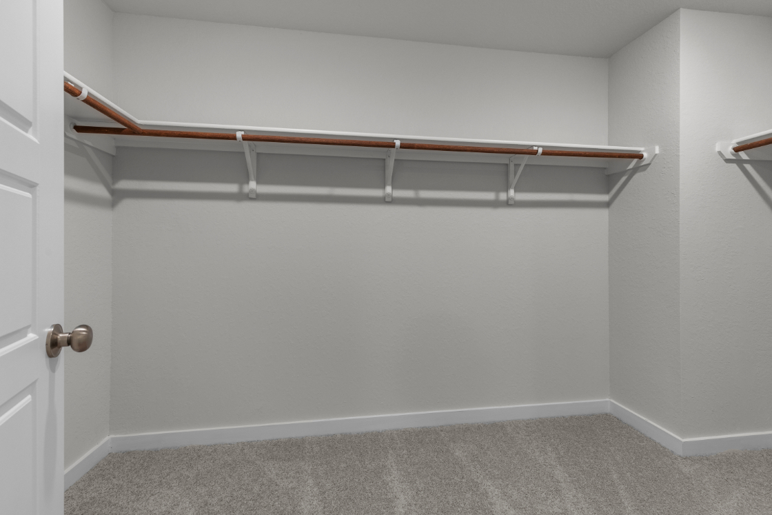 A white wall with a metal bar.
