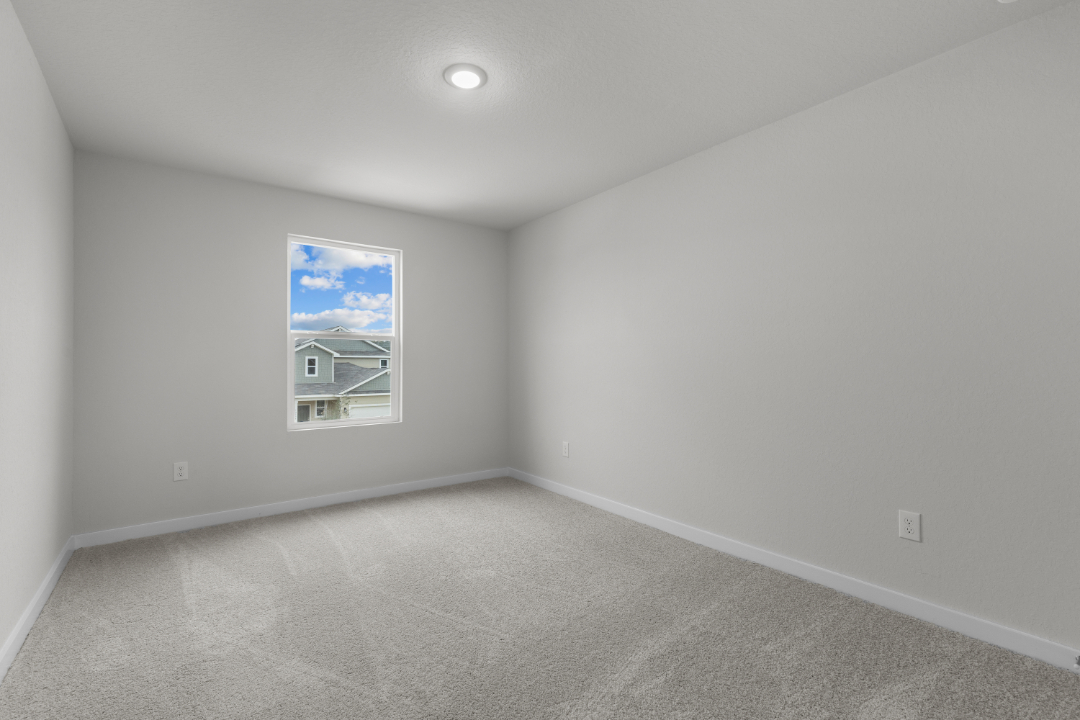 A room with a carpet and a painting on the wall.