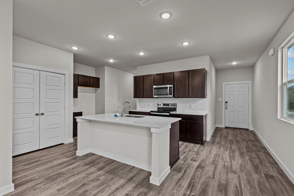 A kitchen with white cabinets.