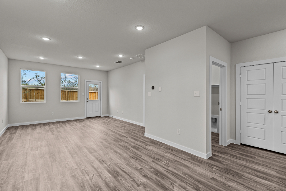 A room with white walls and a wood floor.