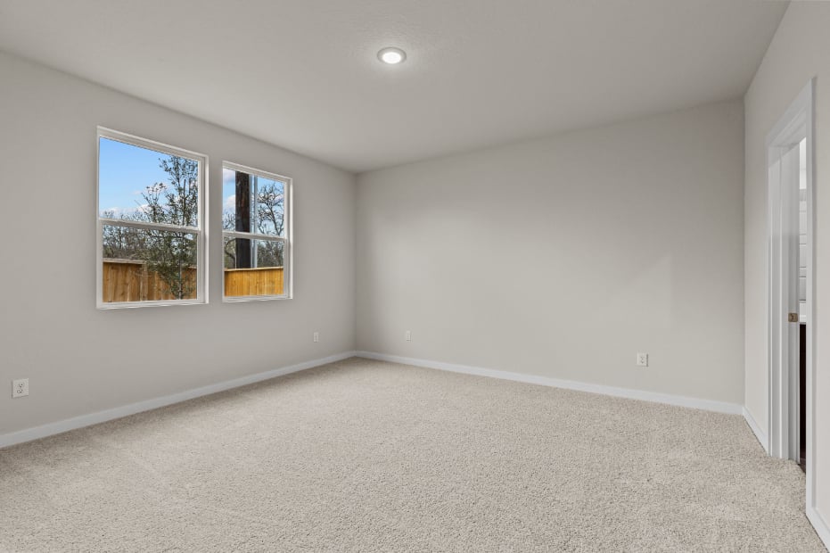 A room with a window and a carpet.